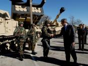 English: President George W. Bush greets army soldiers in front of tank equipment during a visit to Fort Hood in Killeen, Texas, Friday, Jan. 3, 2003.