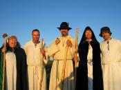 A group of druids from the Sylvan Grove of the Order of Bards Ovates and Druids in the early morning glow of the sun, shortly after having welcomed the sunrise at Stonehenge on the morning of the summer solstice.Left to right: Anne, Richard, Shaun, Marion