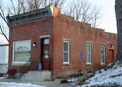 English: Burr Oak Savings Bank, listed on the National Register of Historic Places, being used as the visitor center for the nearby Laura Ingalls Wilder Museum in Burr Oak, Iowa