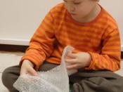 Boy playing with bubble wrap