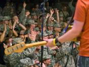 U.S Army soldiers enthusiastically respond to Catchpenny, a Minnesota-based band, during a Memorial Day celebration on Contingency Operating Base Basra, Iraq, May 25. The soldiers are assigned to the 34th Infantry Division, which recently took command of 