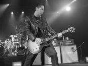 Jonny Wickersham plays guitar in Social Distortion (New York, the Nokia Theatre, 2005 photo by Erika Harding.)