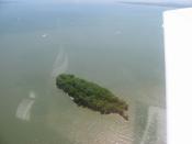 , a small island just off the north point of Catawba Island, one of the in Ottawa County, , . Picture taken from a Diamond Eclipse light airplane at an altitude of 1,550 feet MSL and a bearing of approximately 70º. Wide flat whitish areas in the water are