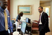 English: President Barack Obama his personal aide Reggie Love share a laugh in his personal secretary office in the White House, June 24, 2009. Personal secretary Katie Johnson (personal secretary) is in the background.