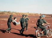 Viet Cong soldiers carry a litter with injured American POW, Capt. David Earle Baker, (captured 27 June 1972) from the hospital tent to the release point. American and South Vietnamese prisoners were exchanged for Viet Cong and North Vietnamese prisoners.