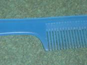 A modern plastic comb with a handle