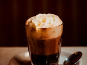 English: Einspaenner Coffee : A viennese specialty. It is a strong black coffee served in a glass topped with whipped cream, it comes with powder sugar served separately.
