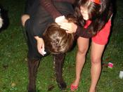 A drunk woman vomits, during a party in Zagreb and a friend helps her.