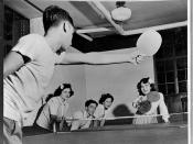 Boy and girl play ping-pong, circa 1950