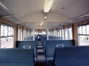 Inside a Class 312 driving trailer open before refurbishment. For second class passengers these trains had 3+2 high-back seating. The passengers behind the driver were able to enjoy the driver's view of the route ahead through the windows between the cab 