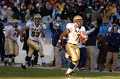 US Navy 051203-N-9693M-508 Navy slot-back Reggie Campbell (7) breaks into the sunshine just prior to crossing the goal line for a touchdown during the 106th Army vs. Navy Football game