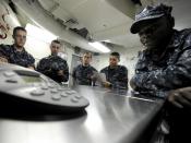 US Navy 101224-N-8824M-098 Sailors aboard the aircraft carrier USS Abraham Lincoln (CVN 72) gather around a telephone speaker for a holiday phone c