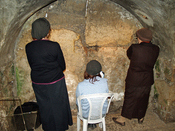 Women praying in the Western Wall tunnels. This is a spot in the tunnel where Jewish women can be physically the closest to the holy of holies, so they face it in that direction and pray at the wall.