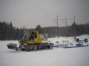 Grooming Unit Of The North Bay Snowmobilers' Club, located in North Bay, Ontario. Tractor unit shown pulling attached drag to maintain, repair, and resurface snowmobile trails.
