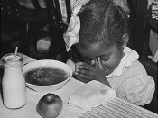English: Young girl prays before eating school lunch of soup, milk, and an apple. 1936. Part of U.S. Works Progress Administration Surplus Commodities: School Lunch Programs during the Great Depression.