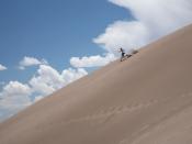 Visitor running down a dune in Great Sand Dunes National Park