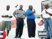 Madden, Mississippi postmaster Bulus Leflore, 2nd from right, receives a copy of Madden NFL 07 and an Xbox 360 from NFL greats, Jerry Rice, right and Marshall Faulk, left, Warren Moon, center, Tuesday, August 22, 2006 as part of Maddenoliday in Madden, Mi