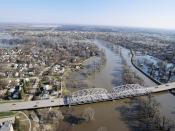 English: Grand Forks, ND, May, 1997 -- Aerial view of Grand Forks neighborhood and a bridge crossing the flooded Red River of the North. The levees that were protecting the city are breeched, flooding the area near the river. FEMA/Michael Rieger
