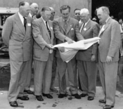 Walt Disney shows Disneyland plans to Orange County officials in December 1954. The men in the front row (left to right) are Anaheim Mayor Charles Pearson, Orange County Supervisor Willis Warner, Walt Disney, Supervisor Willard Smith, and Orange County Pl