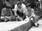 American Author Ernest Hemingway with sons Patrick (left) and Gregory (right) with kittens in Finca Vigia, Cuba.