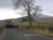 English: Thankerton traffic jam. Thankerton is bypassed, but that does not stop the chaos when the bus from Biggar cannot get past a parked tractor. Tinto in the distance. (A driveby taken during the long wait for the bus driver to get the courage to sque