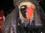 Exotic masquerader in beads, feathers, headdress, and face paint (2004)
