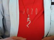 Silver Tibetan seed syllable HUNG, on a red JOYO t-shirt, off the Vancouver BC coast, Lotus Speech Canada