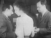 Kay McNulty hands a print-out of ENIAC results to its inventors Pres Eckert (left) and John Mauchly (right) in a newsreel dating from 1946.
