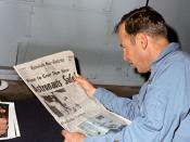 Apollo 13 commander, James A. Lovell, Jr., reads a newspaper account of the safe recovery of Apollo 13