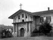 Lower resolution version of Image:CHS.J2289.jpg A view of Mission San Francisco de Asis (Mission Dolores) on Dolores Street in San Francisco, California between 1880 and 1902. The stone building has an arched entryway, columns, a cross, and tile roof. Fra