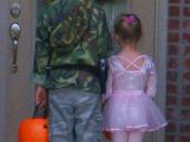 Two cousins, the boy dressed in military camouflage and the girl in a ballerina outfit, wait outside a door as they go trick-or-treating, October 31, 2007.
