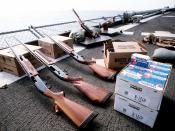 A Remington 870 Wingmaster 12-gauge shotgun, two Remington 1100 12-gauge shotguns, boxes of shells and clay targets are laid out on the fantail of the battleship USS MISSOURI (BB-63) in preparation for skeet shooting practice.