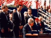 English: President Bill Clinton signing the North American Free Trade Agreement into Law. Al Gore is pictured besides him.