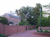 An older area of the University of South Carolina, with bricks of varying age and condition used in a building, several walls and as pavers. Image was taken at coordinates 33° 59' 51.4