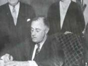 President Franklin Delano Roosevelt signs the act on July 5, 1935. Secretary of Labor Frances Perkins (right) looks on.