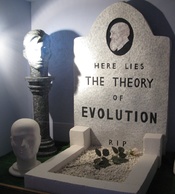 English: Photo of a diorama showing a mock grave for evolution on display at the genesis expo.