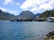 Portion of the dock area at Fagatogo, Pago Pago Harbor, American Samoa with Rainmaker Mt. (Pioa Mtn.) in the background. Photographed by Eric Guinther.