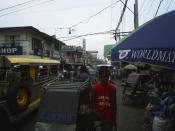 Busy street lined with shops and vendors in Tondo, Manila