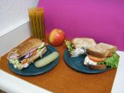 Two sandwiches; on the left a Subway club, on the right an Arby's chicken salad sandwich.