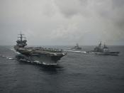 U.S. Navy ships maneuver into formation while transiting the Atlantic Ocean.